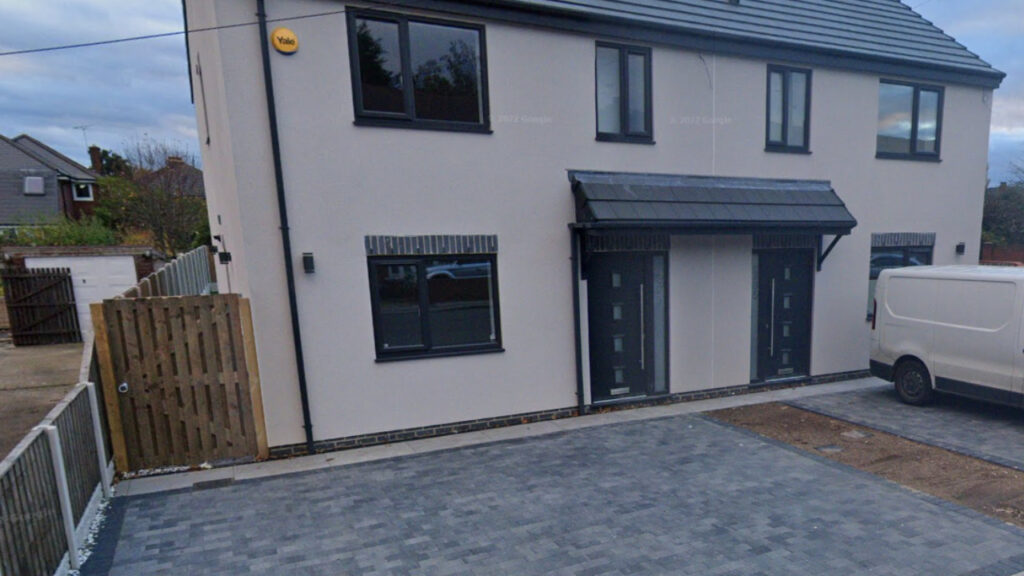 charcoal block Paving with a white rendered house
